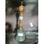 A wood handled brass hand bell