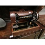 A dome cased manual Singer sewing machine