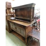 A mid-20th century oak dresser having a raised top back section, the base having two drawers above