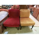 A pair of early 20th century nursing chairs upholstered in cut red and gold fabrics