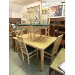 A sycamore effect kitchen table along with a set of five matching chairs