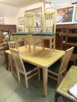 A sycamore effect kitchen table along with a set of five matching chairs