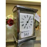 A white metal and five glass cased carriage clock