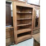 A waxed pine full height corner cabinet having open storage