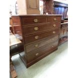 An early 20th century walnut chest of two short over four long graduated drawers