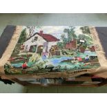 An embroidered wall hanging depicting countryside