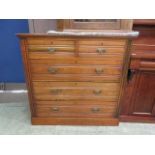 An early 20th century walnut chest of two short over three long drawers