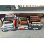 Three trays of hardback books on various subjects to include travel etc.