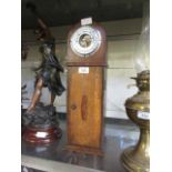 An oak cased standing barometer