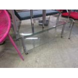 A modern two tier plate glass occasional table