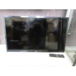 A Samsung flatscreen television with remote