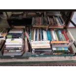 Three trays of hardback and other books of various subjects