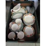 A tray containing a modern part tea set with fruit design comprising of plates, bowls, sauce