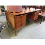 A mid-20th century teak twin pedestal deskDepth - 75cmWidth - 130cmStains and marks to top,