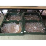 Four trays of glassware to include drinking vessels, vases, etc