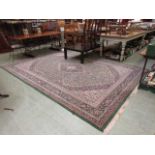 A large rectangular green ground rug, 350 cm x 250 cm