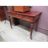 A Victorian style mahogany side table having a pair of drawers flanking lift-up flap