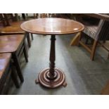 An early 20th century mahogany circular topped pedestal occasional table