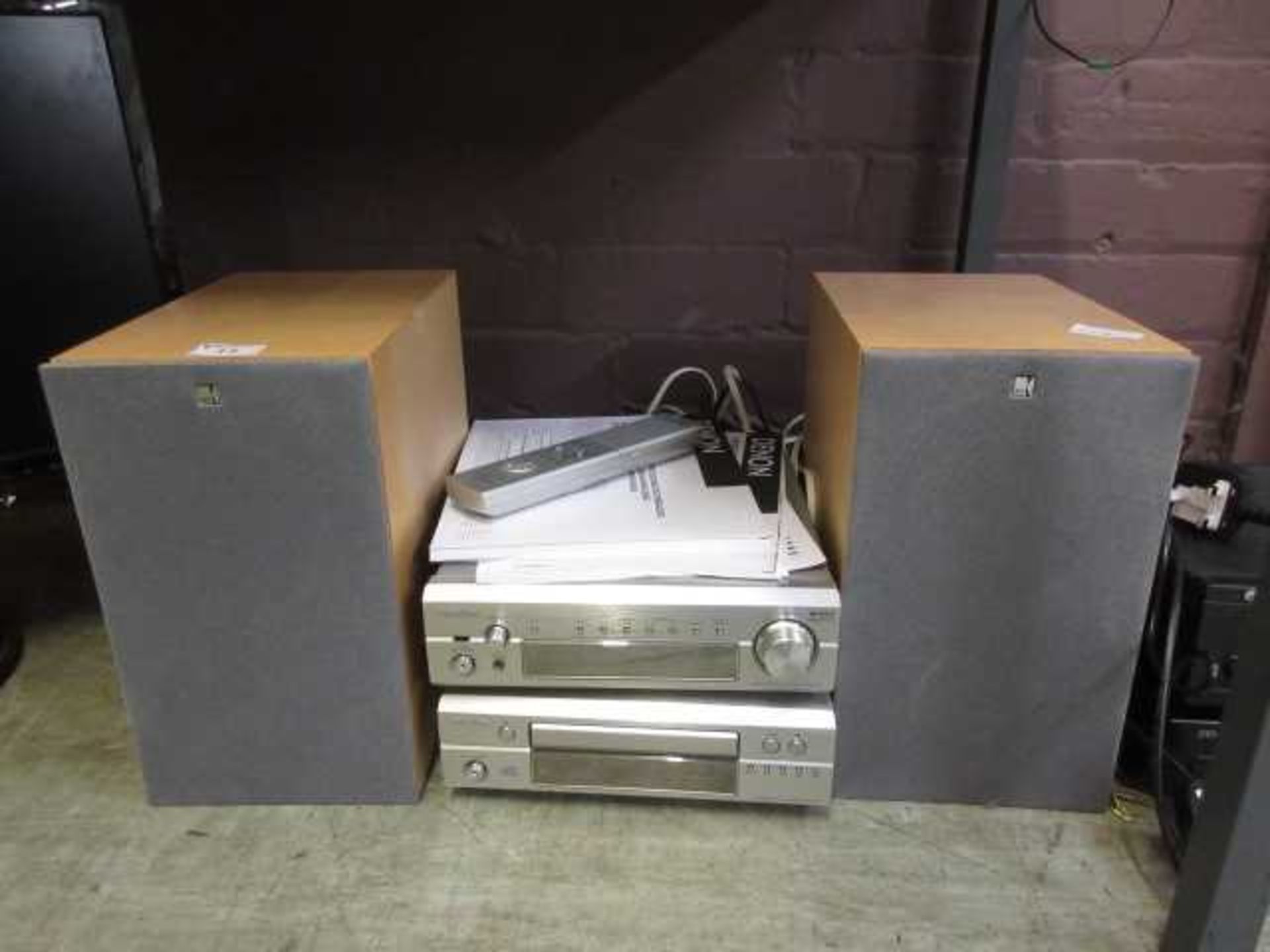 A Denon stereo receiver and CD player along with two KEF speakers