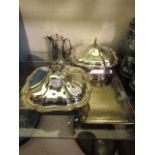 A selection of silver plated items to include serving trays, teapot, glass vase with plated rim,