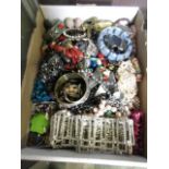 A carton containing a selection of costume jewellery to include bangles, bracelets, pearl necklaces,