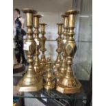 Four pairs of brass candle sticks