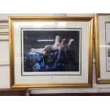 A framed and glazed limited edition print of lounging semi naked lady signed bottom right
