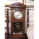 An early 20th century oak cased drop dial wall clock