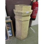 A cream painted chimney pot