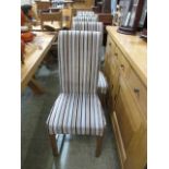 A set of six modern oak framed dining chairs upholstered in a modern striped fabric