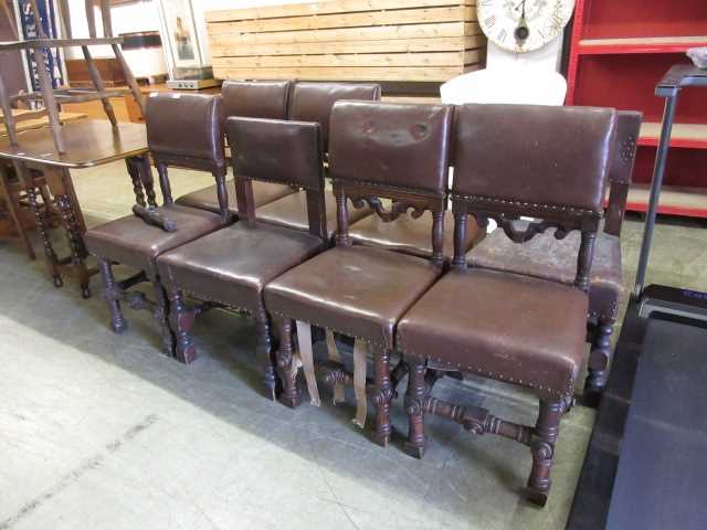 A harlequin set of eight oak framed dining chairs upholstered in a brown leatherette fabric