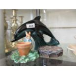 A Poole Pottery dolphin together with a Border Fine Art sculpture from the Peter Rabbit collection