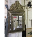 An eastern embossed brass and bevel glass wall hanging cabinet