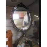 A gilt metal ornate swing pedestal mirror