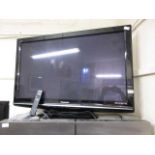 A Panasonic flat screen TV with remote