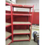 A red metal framed set of shelves