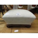 A mahogany framed footstool upholstered in a cut cream fabric