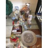 A selection of ceramic and moulded owl figurines along with a small owl design plate by Poole