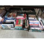 Three trays of hardback books on various subjects many being on travel and novels