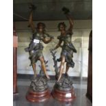 Two spelter figurines of ladies on marble style bases with plaques reading 'Chanson Du Printemps'