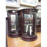 A pair of reproduction mahogany effect dome fronted candle stands