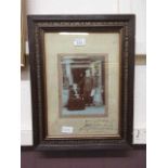 A framed and glazed photograph of elderly people signed bottom right 1907