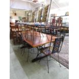 A modern rectangular dining table with metal supports together with a set of eight (Six standard,