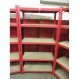A red metal framed set of shelves