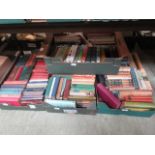 Four trays of hardback books on various subjects and authors