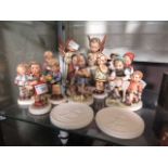 A selection of Hummel figurines to include children with animals, children playing music, etc