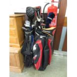 A red golf bag and a black golf bag containing an assortment of golf clubs