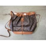 A tan leather and printed handbag