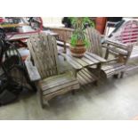 A weathered wooden garden twin seat with centre table