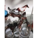 A selection of nine ceramic figurines of horses, donkeys, and foals, some of which by Beswick